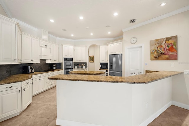 kitchen featuring white cabinetry, backsplash, dark stone counters, light tile patterned flooring, and black appliances