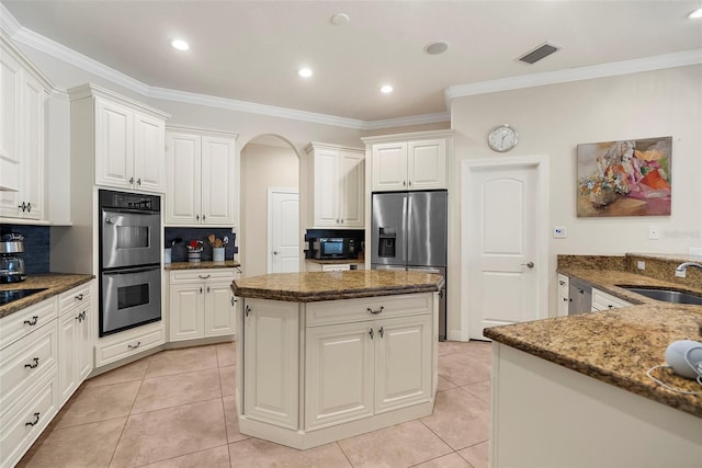 kitchen featuring white cabinets, sink, appliances with stainless steel finishes, and tasteful backsplash