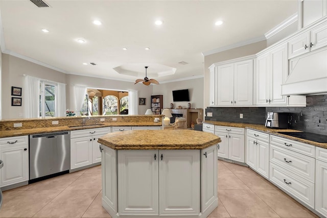 kitchen featuring black electric stovetop, white cabinets, ceiling fan, dishwasher, and a kitchen island