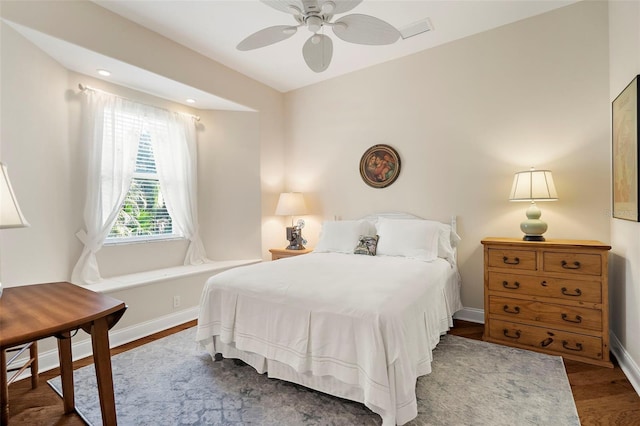 bedroom with ceiling fan and dark hardwood / wood-style flooring