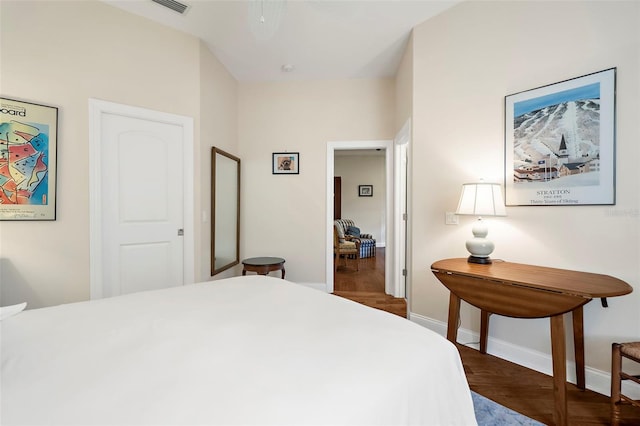 bedroom with dark hardwood / wood-style flooring