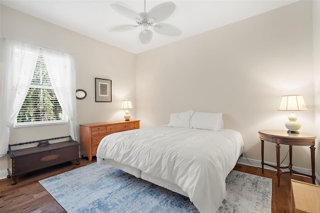 bedroom with ceiling fan and dark wood-type flooring