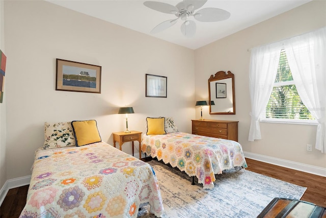 bedroom with ceiling fan and dark wood-type flooring