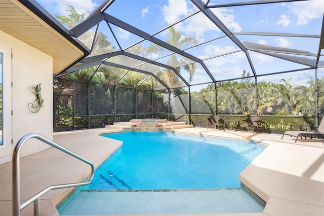 view of pool featuring glass enclosure, a patio area, and an in ground hot tub