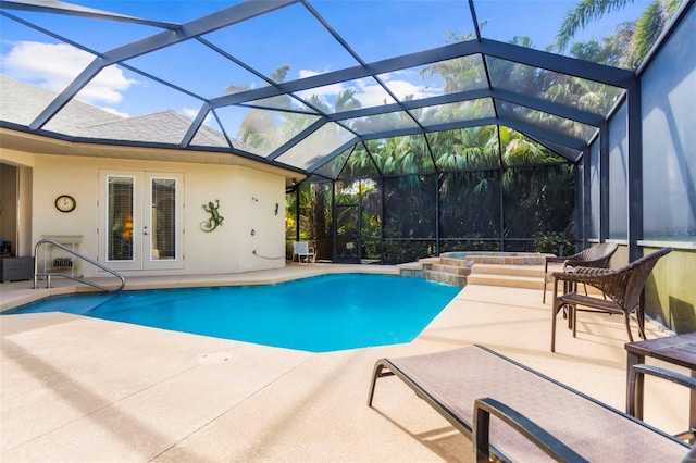 view of swimming pool featuring an in ground hot tub, french doors, a patio, and glass enclosure