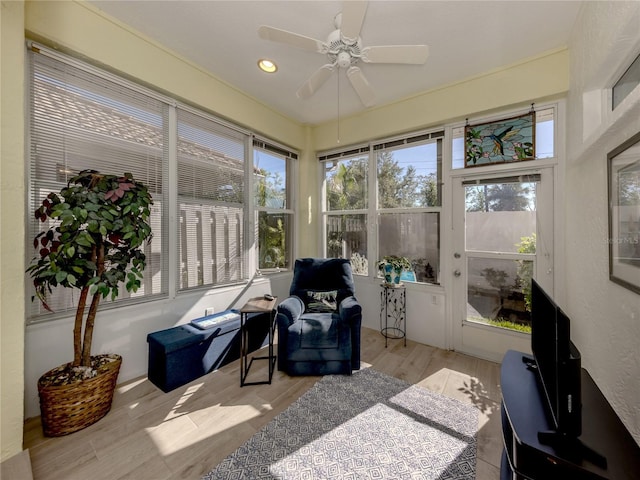 sunroom / solarium featuring ceiling fan