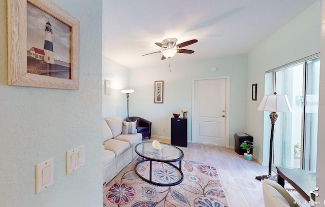 living room with ceiling fan and light wood-type flooring