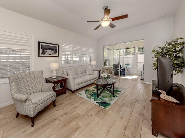 living room featuring light hardwood / wood-style flooring, ceiling fan, and lofted ceiling