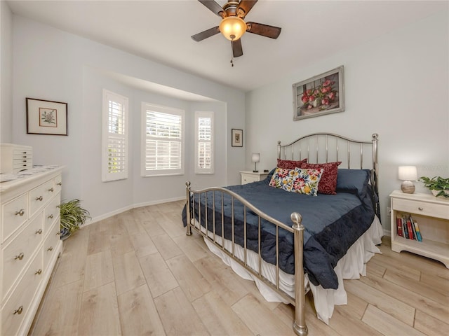 bedroom with light hardwood / wood-style flooring and ceiling fan