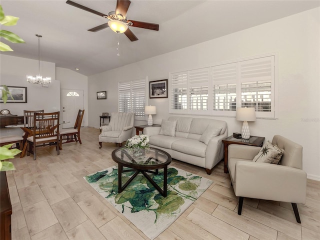 living room featuring light hardwood / wood-style flooring, ceiling fan with notable chandelier, and vaulted ceiling