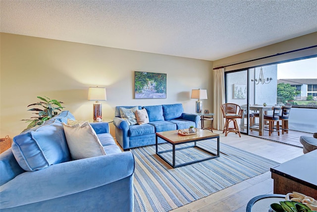 living room with light hardwood / wood-style floors and a textured ceiling