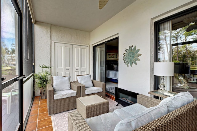 sunroom / solarium featuring ceiling fan