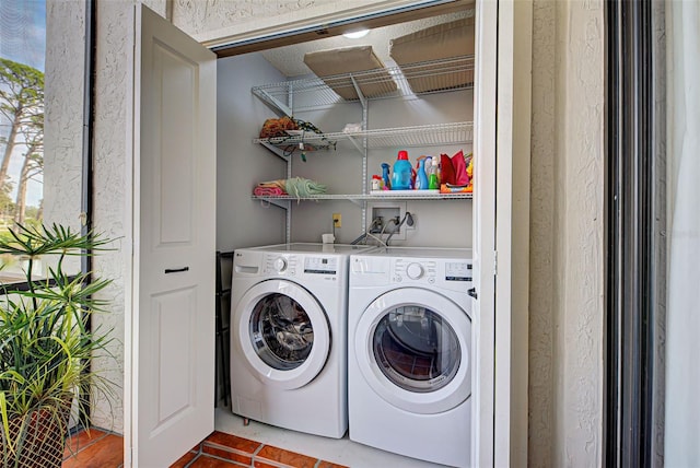 laundry area with tile patterned flooring and washer and dryer