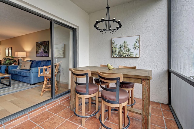 dining space with tile patterned flooring and a notable chandelier