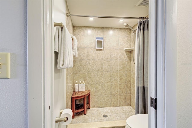 bathroom featuring curtained shower and toilet