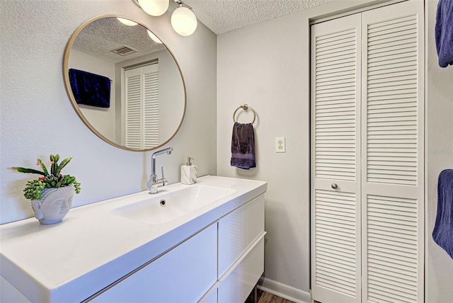 bathroom featuring vanity and a textured ceiling