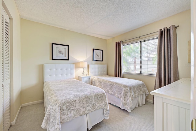 carpeted bedroom featuring a closet and a textured ceiling