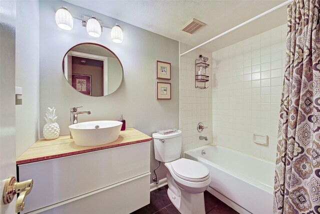 full bathroom featuring toilet, shower / bath combination with curtain, vanity, and tile patterned floors