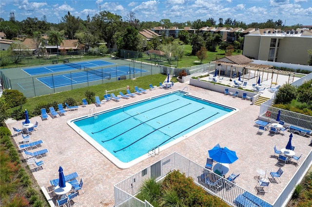 view of pool featuring tennis court