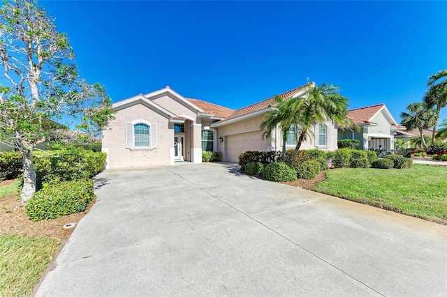 single story home with a garage and a front yard