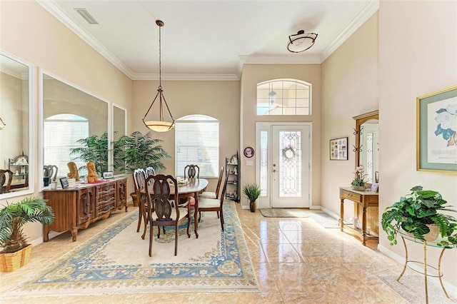 dining space with a wealth of natural light and crown molding