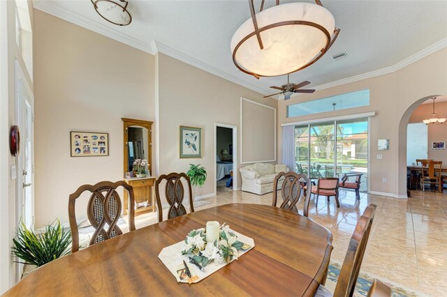 dining area with crown molding and ceiling fan