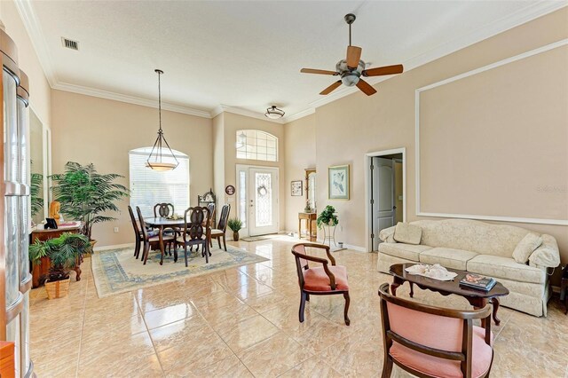 living room featuring ceiling fan and ornamental molding