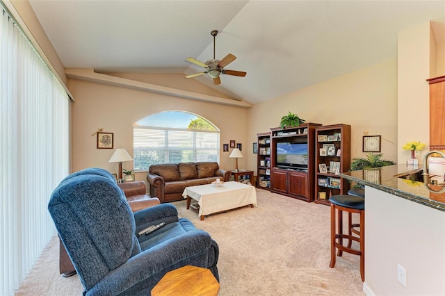 carpeted living room featuring ceiling fan and vaulted ceiling