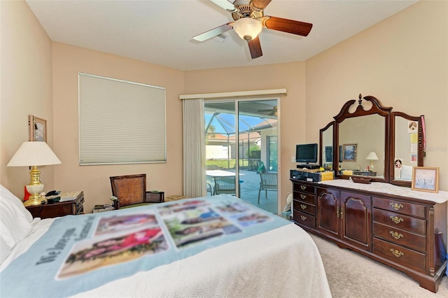 carpeted bedroom with ceiling fan and access to outside