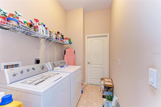 clothes washing area with light tile patterned floors and washing machine and dryer