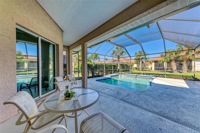 view of swimming pool with a lanai and a patio area