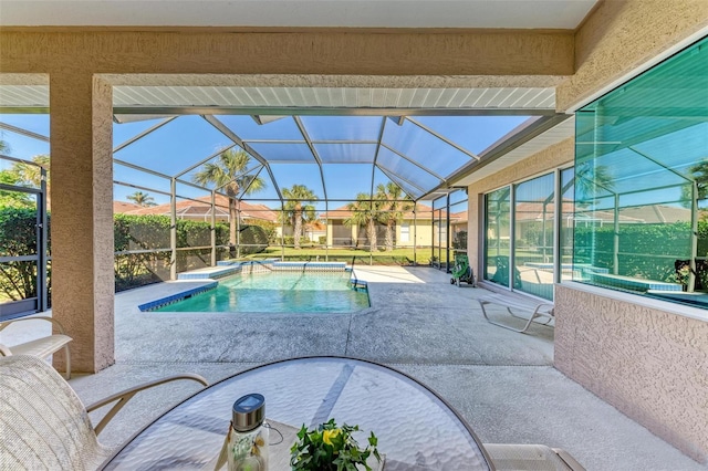 view of swimming pool featuring a patio area and glass enclosure