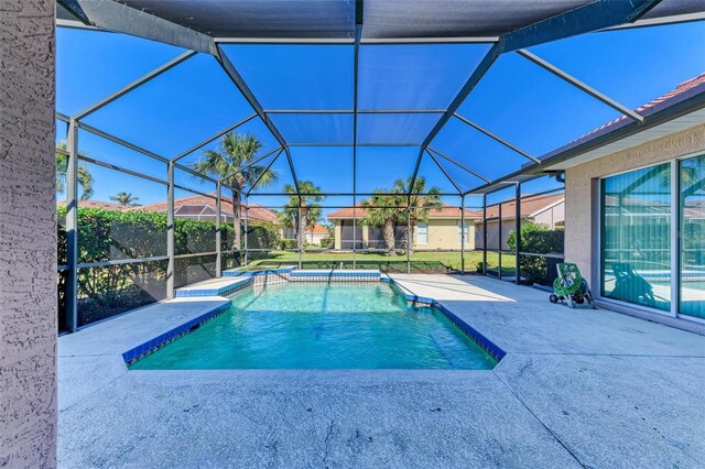 view of swimming pool featuring a lanai and a patio