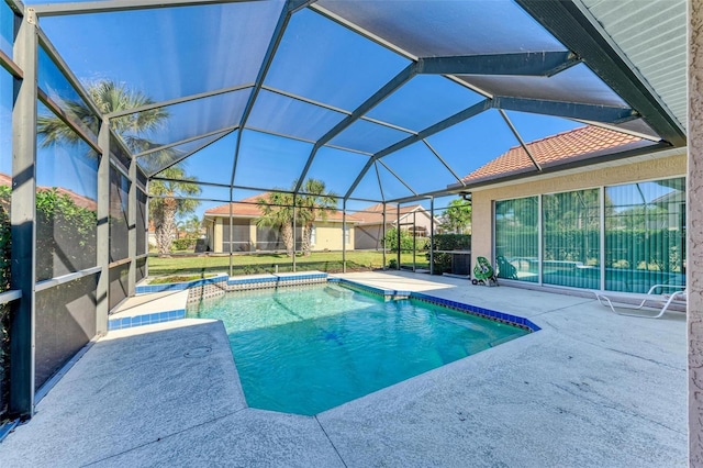 view of swimming pool featuring glass enclosure and a patio