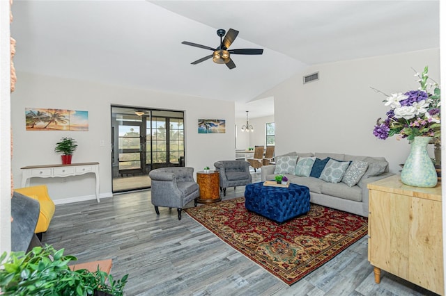 living room featuring lofted ceiling, hardwood / wood-style floors, and ceiling fan