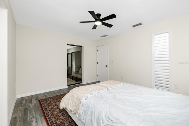 bedroom with ceiling fan and dark hardwood / wood-style flooring