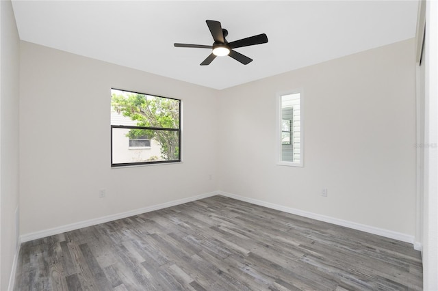 spare room with ceiling fan, plenty of natural light, and hardwood / wood-style floors