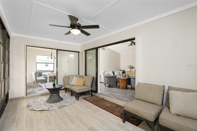 sitting room featuring crown molding, ceiling fan, and hardwood / wood-style floors