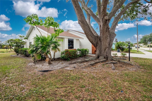 view of side of home featuring a yard