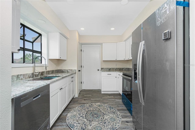 kitchen featuring sink, white cabinetry, stainless steel fridge, dishwasher, and range with electric cooktop