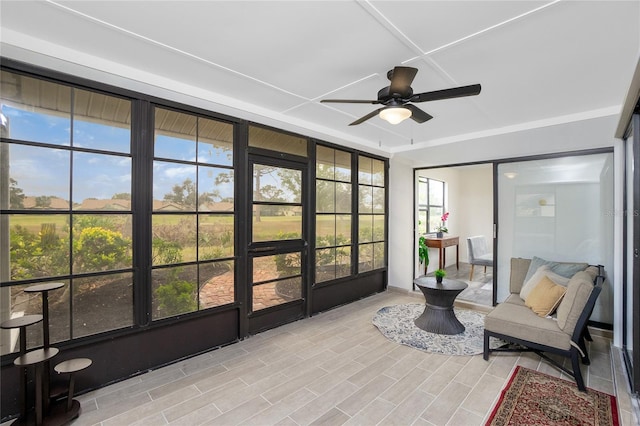 sunroom with ceiling fan and a healthy amount of sunlight