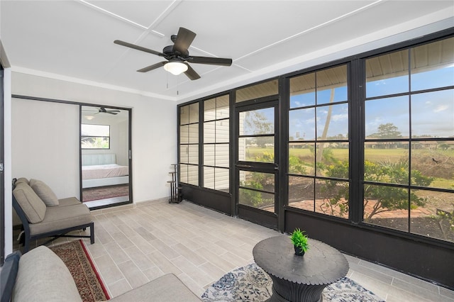 sunroom featuring ceiling fan