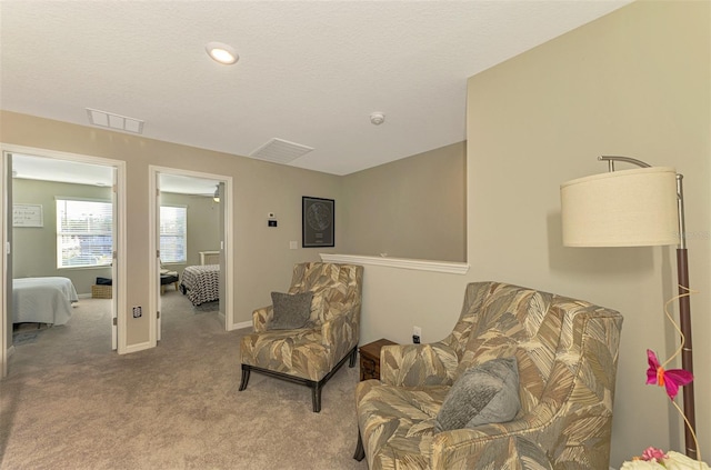 sitting room featuring light colored carpet