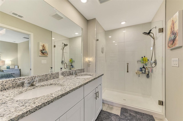 bathroom with vanity, tile patterned floors, and a shower with door