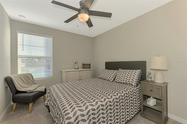 carpeted bedroom with ceiling fan and multiple windows