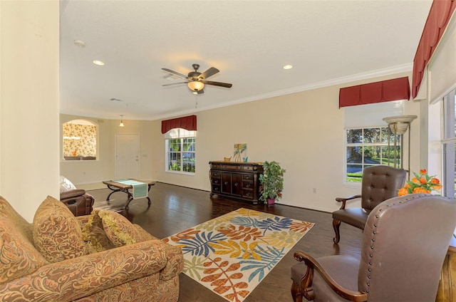 living room featuring crown molding, ceiling fan, and dark hardwood / wood-style floors