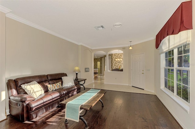 living room featuring wood-type flooring and crown molding