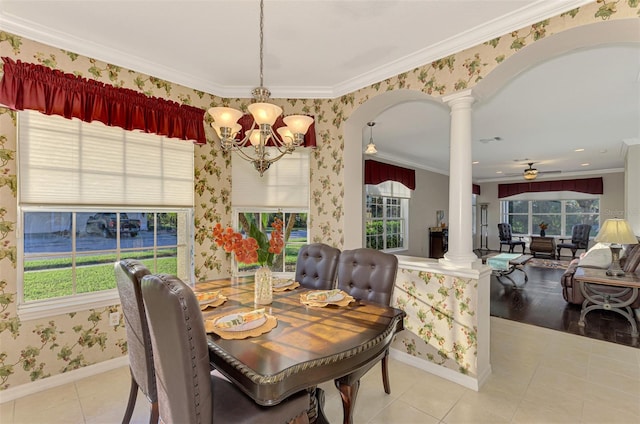 dining area featuring ornate columns, light hardwood / wood-style floors, ceiling fan with notable chandelier, and ornamental molding