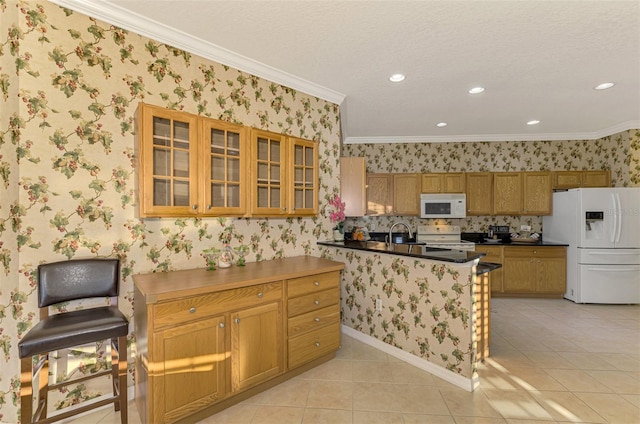 kitchen with white appliances, a kitchen breakfast bar, crown molding, light tile patterned flooring, and kitchen peninsula