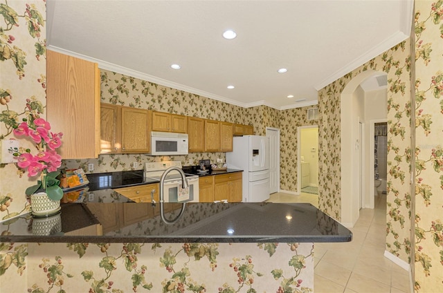 kitchen featuring a kitchen breakfast bar, white appliances, kitchen peninsula, and ornamental molding